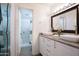 Stylish bathroom featuring dual vessel sinks, granite countertops, and a walk-in shower at 5223 N 24Th St # 108, Phoenix, AZ 85016