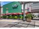 Exterior view of Blanco Tacos + Tequila restaurant featuring a green facade and red umbrellas at 5223 N 24Th St # 108, Phoenix, AZ 85016