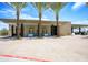 Club house exterior featuring an outdoor patio, palm trees, and desert landscaping at 5223 N 24Th St # 108, Phoenix, AZ 85016