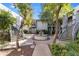 Picturesque courtyard view showcasing a beautiful fountain, mature trees, and well-maintained landscaping at 5223 N 24Th St # 108, Phoenix, AZ 85016