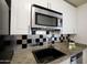 Bright kitchen featuring granite countertops, stainless steel appliances, and modern fixtures at 5223 N 24Th St # 108, Phoenix, AZ 85016