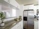 Well-lit kitchen with stainless steel appliances, granite counters, and modern cabinetry at 5223 N 24Th St # 108, Phoenix, AZ 85016