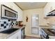 Functional kitchen with a stainless steel sink, granite countertops, and classic black and white backsplash at 5223 N 24Th St # 108, Phoenix, AZ 85016