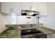 Efficient kitchen with granite countertops, stainless steel appliances, and views to the dining area at 5223 N 24Th St # 108, Phoenix, AZ 85016