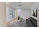 Modern living room with a gray rug, black sofa, natural light, and view of outdoor fountain at 5223 N 24Th St # 108, Phoenix, AZ 85016