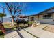 Enclosed patio, brick fence, and landscaping in this private backyard at 5223 W Lewis Ave, Phoenix, AZ 85035