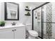 Modern bathroom featuring sleek vanity, toilet, and a stylish tile shower with glass door at 5223 W Lewis Ave, Phoenix, AZ 85035