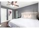 Relaxing bedroom featuring a ceiling fan, soft lighting, and a cozy, upholstered bed frame at 5223 W Lewis Ave, Phoenix, AZ 85035