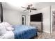 Bright, clean bedroom with wood-look flooring, ceiling fan, and neutral-colored walls at 5223 W Lewis Ave, Phoenix, AZ 85035