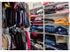 Walk in closet with rods and shelves filled with clothing items at 5223 W Lewis Ave, Phoenix, AZ 85035