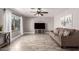 Living room featuring neutral paint, wood-look tile floors, a large window, and recessed lighting at 5223 W Lewis Ave, Phoenix, AZ 85035