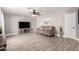 Spacious living room featuring wood-look tile flooring, neutral paint, and a ceiling fan at 5223 W Lewis Ave, Phoenix, AZ 85035