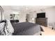 View of the primary bedroom with sliding closet doors, gray walls, and light-colored floors at 5223 W Lewis Ave, Phoenix, AZ 85035