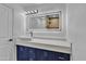 Modern bathroom with vessel sink, quartz countertop, blue vanity, and LED mirror at 5942 W Seldon Ln, Glendale, AZ 85302