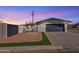 Charming single-story home featuring a two-car garage and a low-maintenance front yard under a beautiful purple sky at 5942 W Seldon Ln, Glendale, AZ 85302