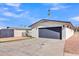 Charming single-story home featuring a gray two-car garage and low-maintenance desert landscaping at 5942 W Seldon Ln, Glendale, AZ 85302