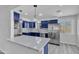 Modern kitchen featuring navy blue cabinets, stainless steel appliances, a white countertop island and recessed lighting at 5942 W Seldon Ln, Glendale, AZ 85302