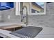 Updated kitchen showcasing white backsplash tiles and a modern gooseneck faucet at 5942 W Seldon Ln, Glendale, AZ 85302