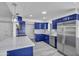 Modern kitchen with blue cabinets, quartz counters, and stainless-steel appliances at 5942 W Seldon Ln, Glendale, AZ 85302