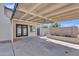 Back patio featuring ceiling fan, decorative block wall, and flower bed at 5942 W Seldon Ln, Glendale, AZ 85302