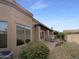 Backyard view features a covered patio, low maintenance landscaping, and stucco wall at 6202 E Mckellips Rd # 227, Mesa, AZ 85215