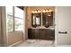 Bathroom featuring double sinks, sconces, and tile flooring at 7500 E Deer Valley Rd # 59, Scottsdale, AZ 85255