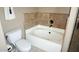 Bathroom showcasing a soaking tub and tiled walls at 7500 E Deer Valley Rd # 59, Scottsdale, AZ 85255