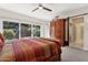 Bedroom with a large window overlooking the exterior landscape and a wooden dresser at 7504 N Via De La Siesta --, Scottsdale, AZ 85258