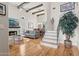 Bright and airy living room featuring hardwood floors, a fireplace, and a staircase with metal railing at 7504 N Via De La Siesta --, Scottsdale, AZ 85258