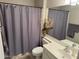 Cozy bathroom with a shower curtain, vanity with sink, and decorative accents, creating a functional space at 7887 N 16Th St # 227, Phoenix, AZ 85020