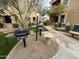 Community outdoor grilling area featuring two grills, seating, and desert landscaping at 7887 N 16Th St # 227, Phoenix, AZ 85020