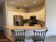 Open kitchen with white cabinets, stainless steel appliances, and a breakfast bar at 7887 N 16Th St # 227, Phoenix, AZ 85020