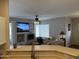 Open floor plan with living room featuring a fireplace, ceiling fan, tv, and comfortable seating at 7887 N 16Th St # 227, Phoenix, AZ 85020