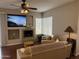 Living room with a ceiling fan, fireplace, large TV, and comfortable seating area at 7887 N 16Th St # 227, Phoenix, AZ 85020