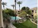 Community pool featuring palm trees, chaise lounges, grass and lush landscaping in a desert climate at 7887 N 16Th St # 227, Phoenix, AZ 85020