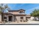 Front exterior of the house with low maintenance desert rock landscaping in front and a tile roof at 8134 W Beck Ln, Peoria, AZ 85382