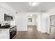 Eat-in kitchen with new stainless steel appliances and new vinyl flooring overlooking the Gathering room at 8248 W Whitton Ave, Phoenix, AZ 85033