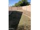 Backyard with desert landscaping, grass and a privacy wall at 8648 W Fargo Dr, Peoria, AZ 85382