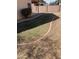 A backyard with a small grass area, desert landscaping and a privacy wall at 8648 W Fargo Dr, Peoria, AZ 85382