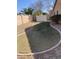 Landscaped backyard featuring grass, gravel, and a metal shed for storage surrounded by a block fence for added privacy at 8648 W Fargo Dr, Peoria, AZ 85382