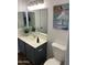 Well-lit bathroom featuring a single vanity with a gray cabinet, a toilet, and a decorative painting at 8648 W Fargo Dr, Peoria, AZ 85382