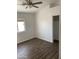 Bright bedroom featuring wood flooring, a ceiling fan, and a walk-in closet at 8648 W Fargo Dr, Peoria, AZ 85382