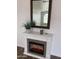 Cozy electric fireplace with decorative mirror, adding a modern touch at 8648 W Fargo Dr, Peoria, AZ 85382