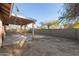 Backyard with covered patio and block fence at 8709 W Roanoke Ave, Phoenix, AZ 85037