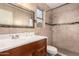 Bathroom features shower, vanity, and earth tones at 8709 W Roanoke Ave, Phoenix, AZ 85037