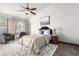 Well-lit bedroom boasts ceiling fan, neutral tones, and decorative accents at 8709 W Roanoke Ave, Phoenix, AZ 85037