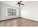 Bedroom with a large window and ceiling fan at 8709 W Roanoke Ave, Phoenix, AZ 85037