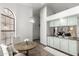 Sunlit breakfast nook showcases table, chairs, and nearby kitchen at 8709 W Roanoke Ave, Phoenix, AZ 85037