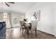 Cozy dining area with a wooden table, four chairs, and a picturesque view through the sliding glass doors at 8709 W Roanoke Ave, Phoenix, AZ 85037