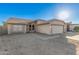 Attractive home with a neutral stucco exterior and a well-maintained, low-water front yard at 8709 W Roanoke Ave, Phoenix, AZ 85037